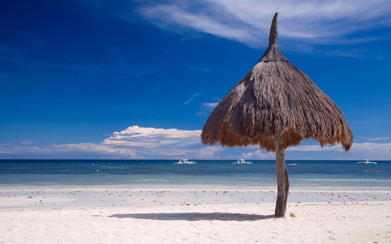 Thatched Beach Umbrella — Blue, Serene, Afternoon, Photograph