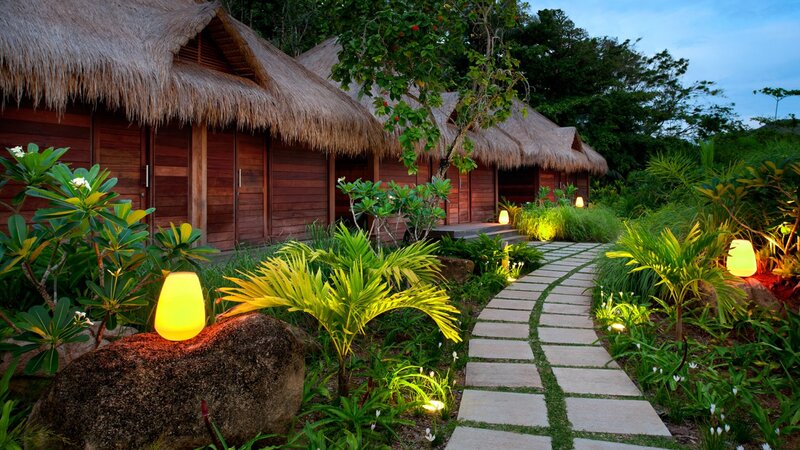 Thatched Bungalows at Dusk
