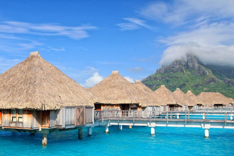 Thatched Bungalows on Water — Blue, Serene, Afternoon, Photograph, Mountain