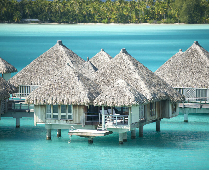 Thatched Bungalows on Water — Blue, Serene, Afternoon, Photograph, Ocean
