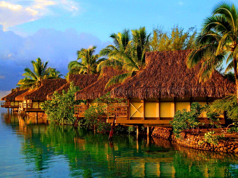 Thatched Bungalows on Water — Blue, Serene, Sunset
