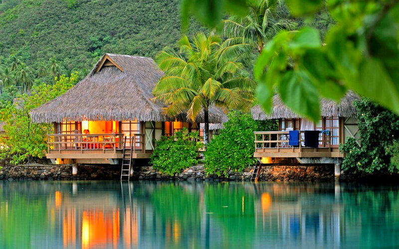 Thatched Bungalows on Water — Green, Serene, Night