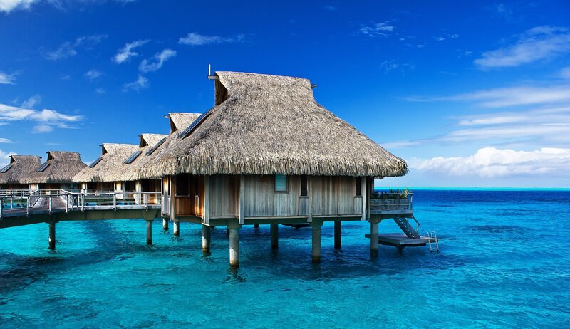 Thatched Bungalows over Water — Blue, Serene, Afternoon