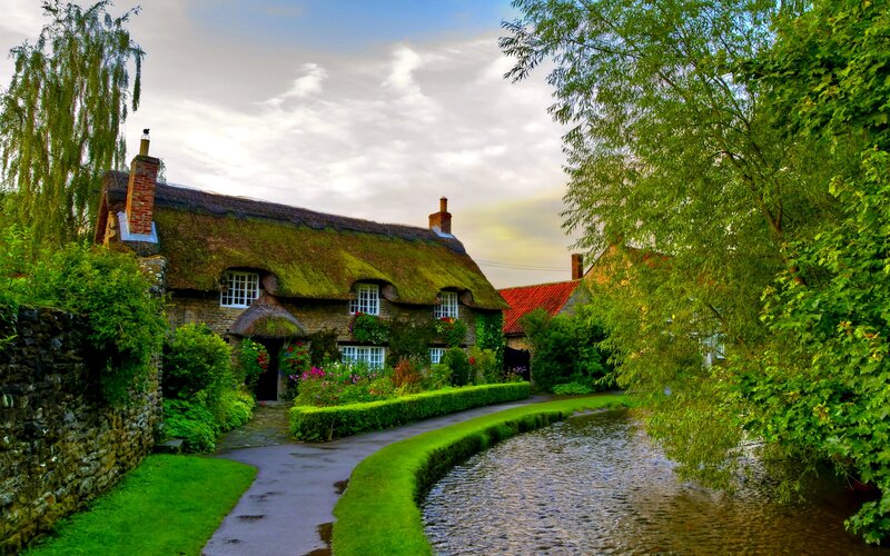 Thatched Cottage by River — Green, Serene, Afternoon, Photograph, Garden