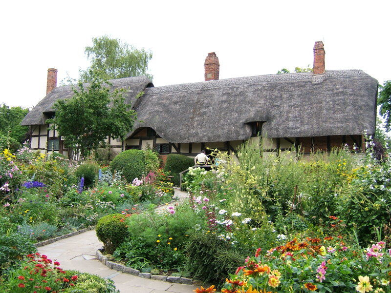 Thatched cottage in a flower garden