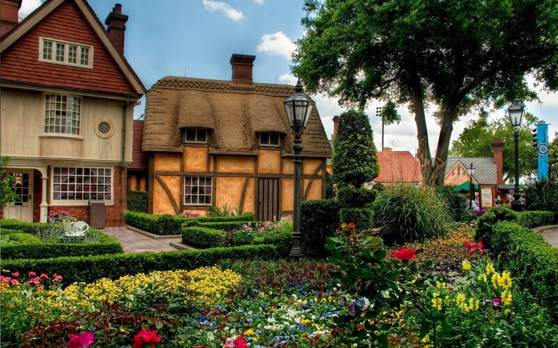 Thatched cottage in a flower garden