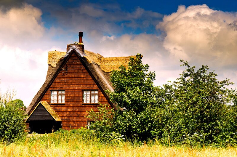Thatched cottage in rural landscape