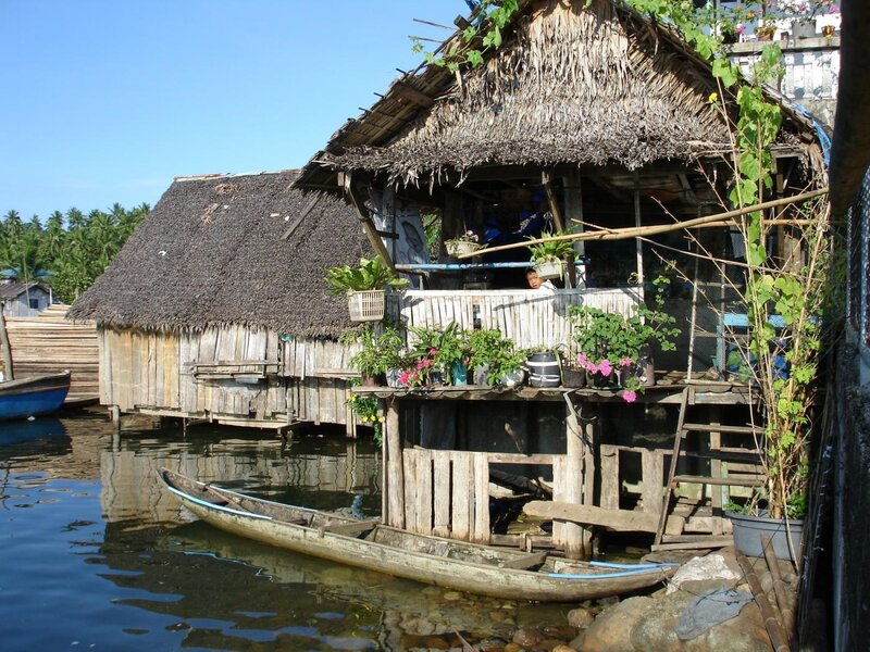 Thatched houses on stilts by water