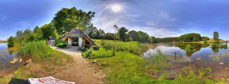 Thatched Hut by Pond