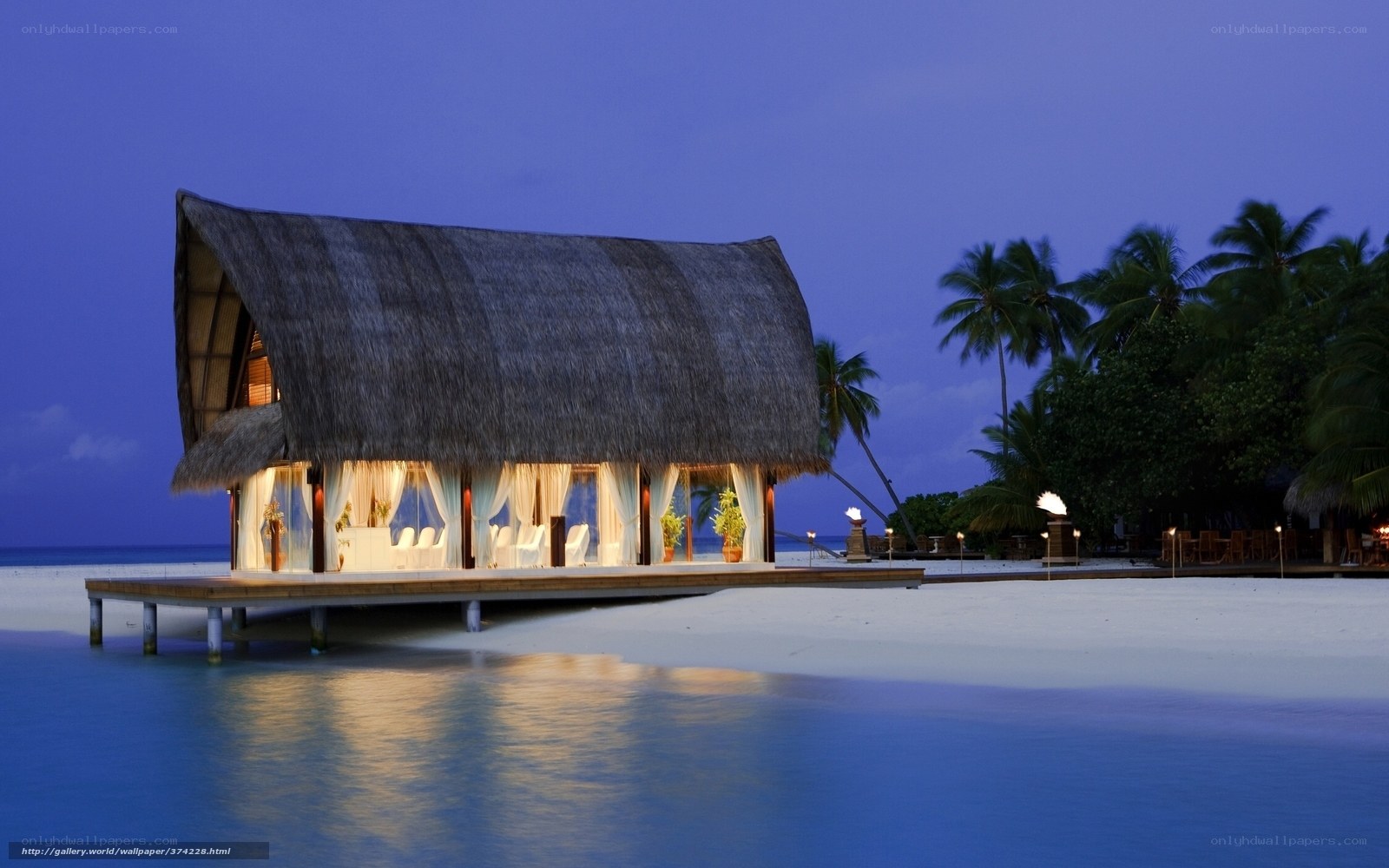 thatched hut on beach at dusk