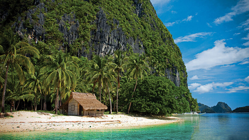 Thatched Hut on Beach — Blue, Serene, Afternoon, Photograph, Palm Trees, Cliff