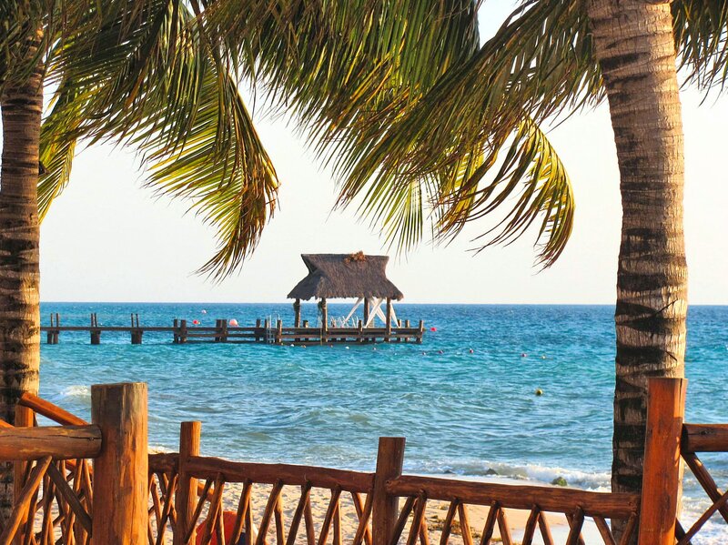 Thatched Hut on Pier — Blue, Serene, Afternoon, Photograph, Palm Trees