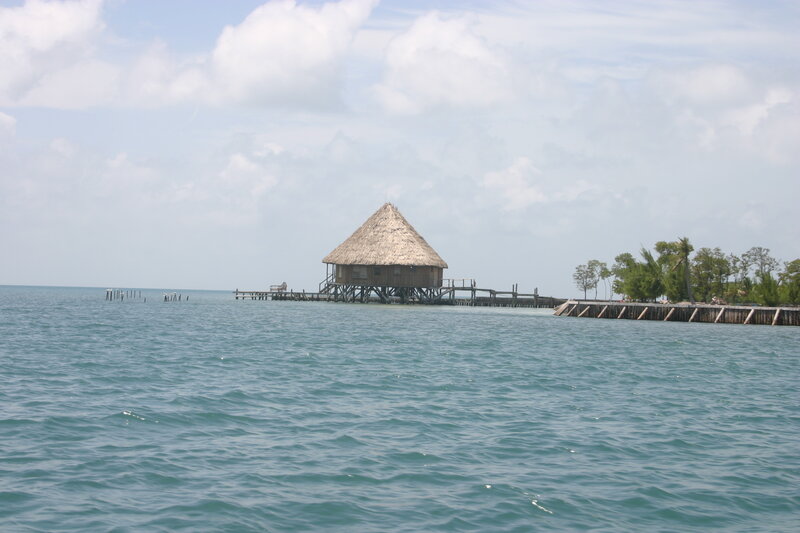 Thatched Hut on Pier — Blue, Serene, Afternoon