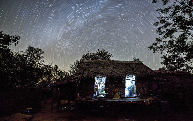 Thatched Hut under Star Trails