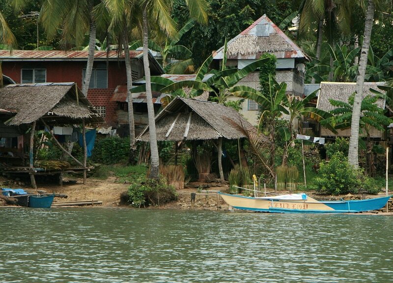 Thatched Huts by Water