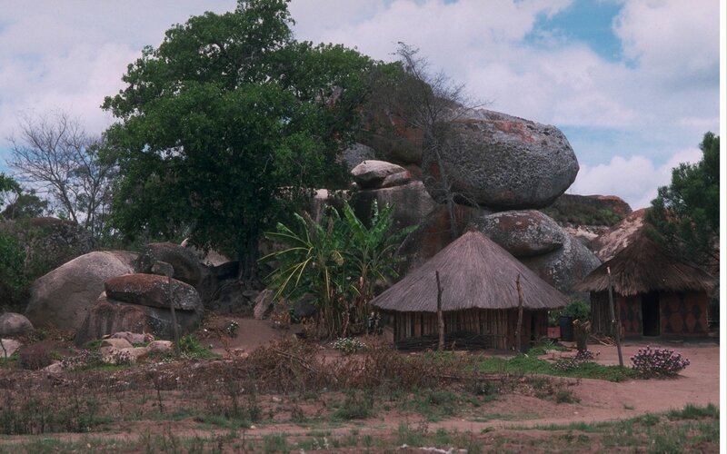 Thatched Huts Near Rocks