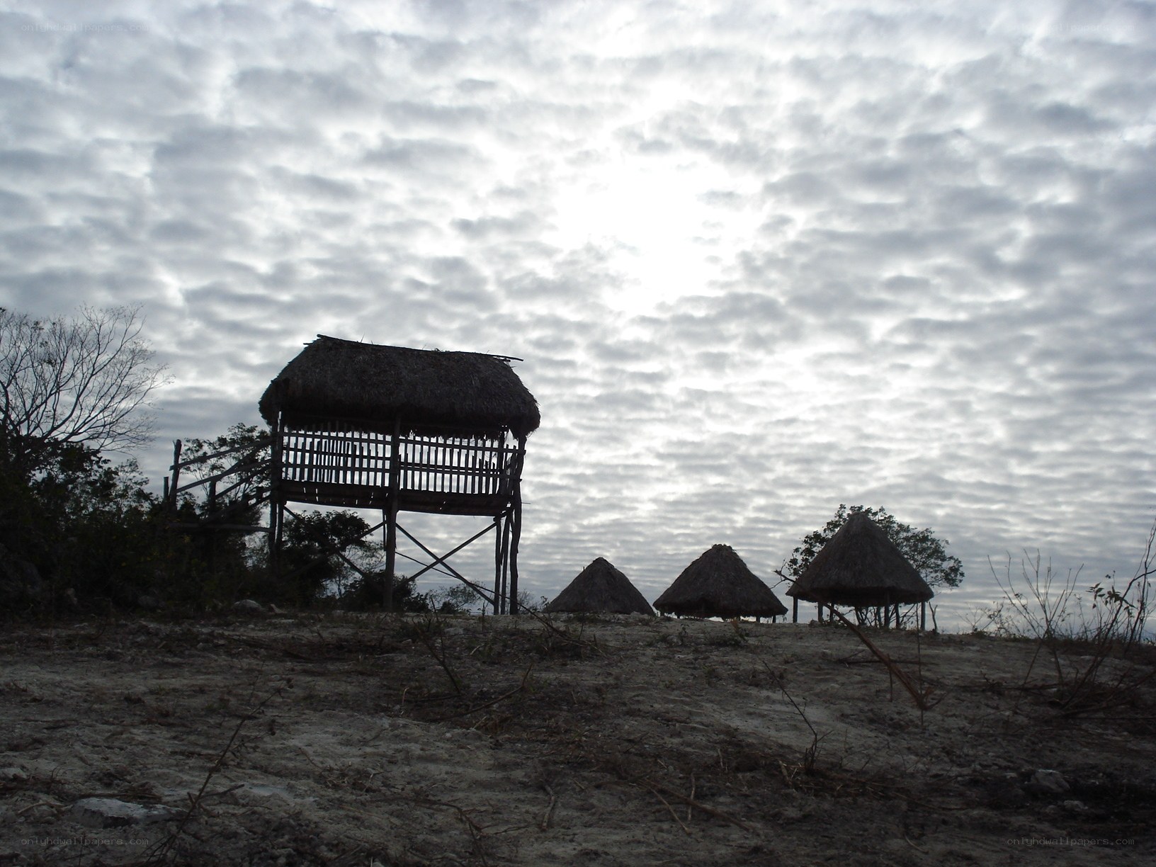 Thatched huts on a cloudy day