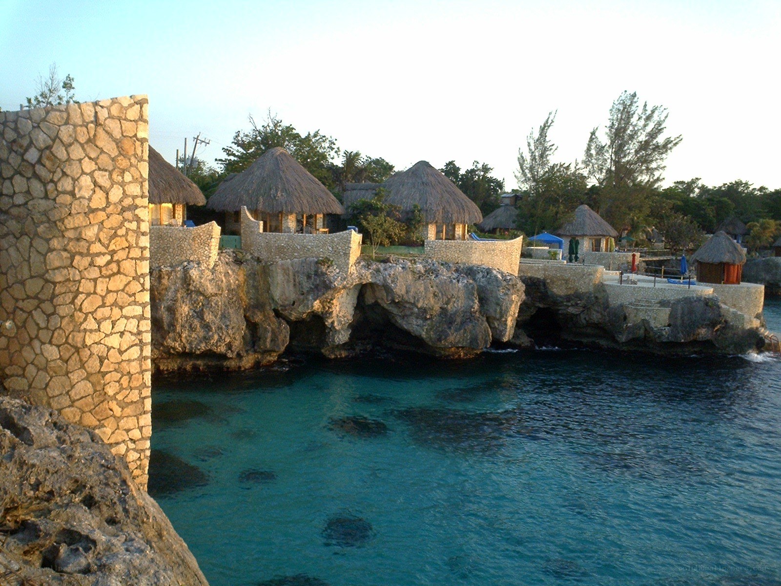 Thatched huts on a rocky coast