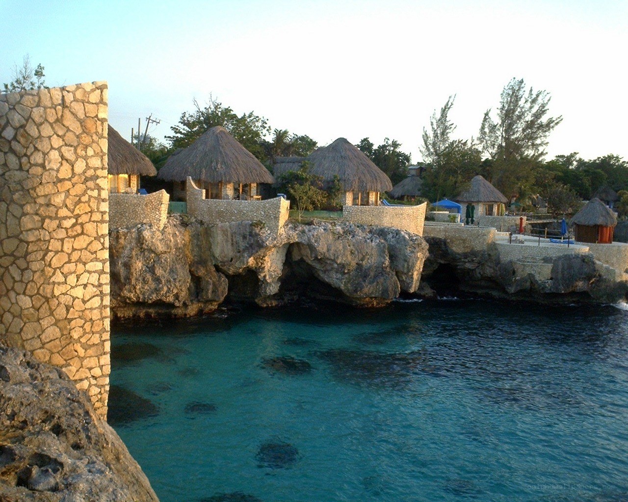 Thatched huts on a rocky coast
