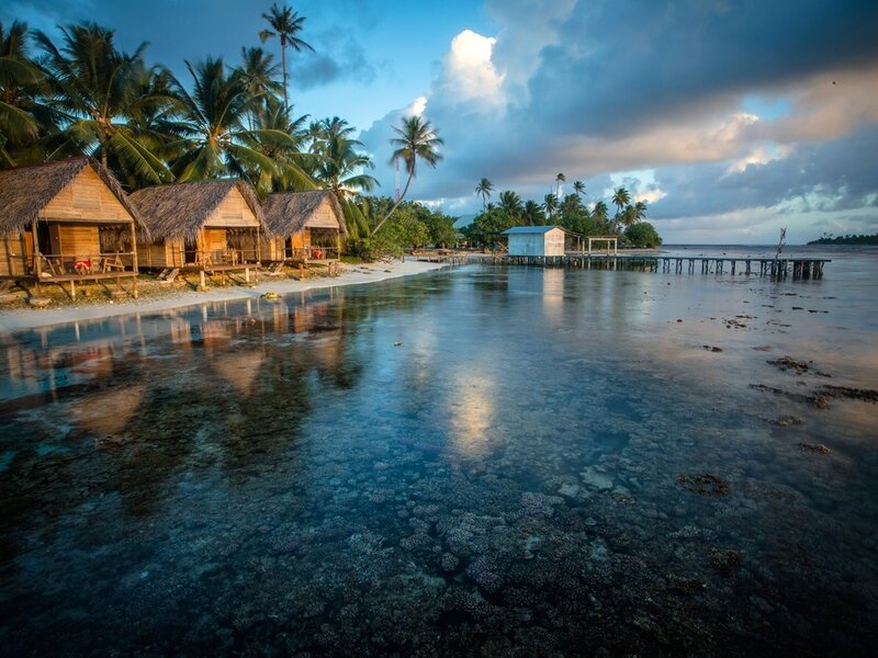 Thatched Huts on Beach — Blue, Serene, Sunset, Photograph, Palm Trees, Coral Reef, Dock