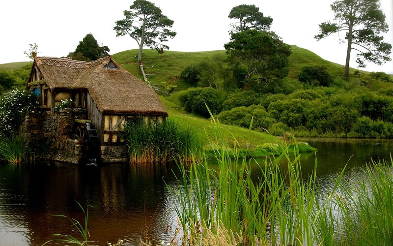 thatched mill by a river