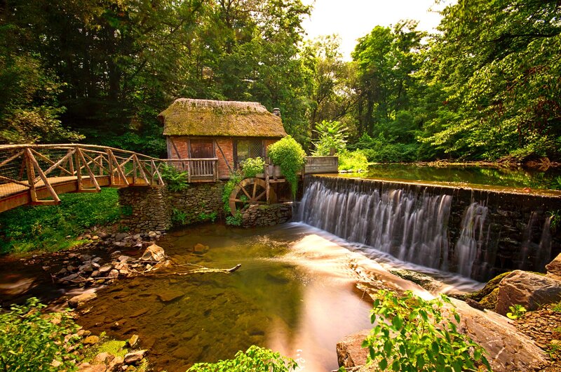 Thatched Mill by Waterfall