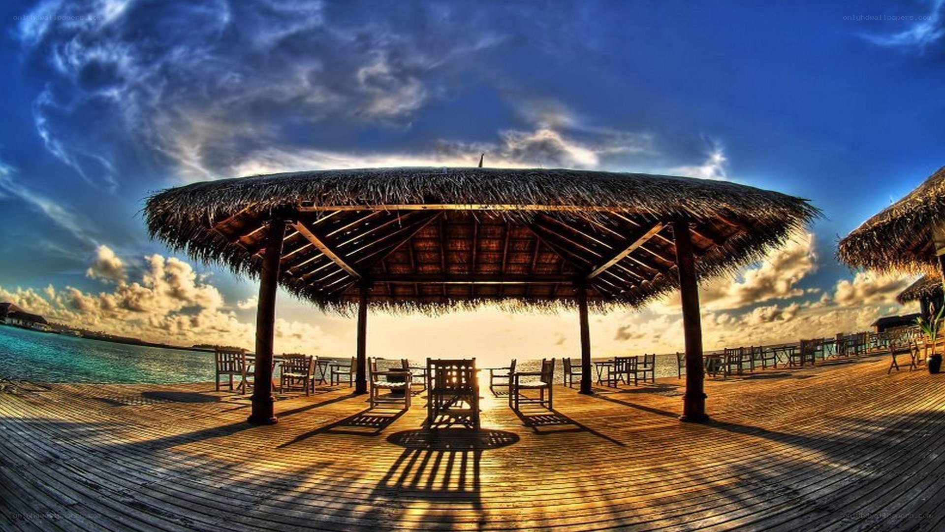 thatched pavilion at sunset