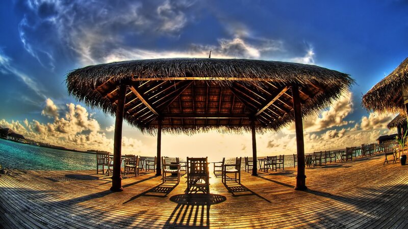 Thatched pavilion at sunset