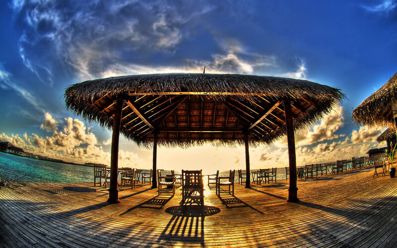 Thatched pavilion at sunset