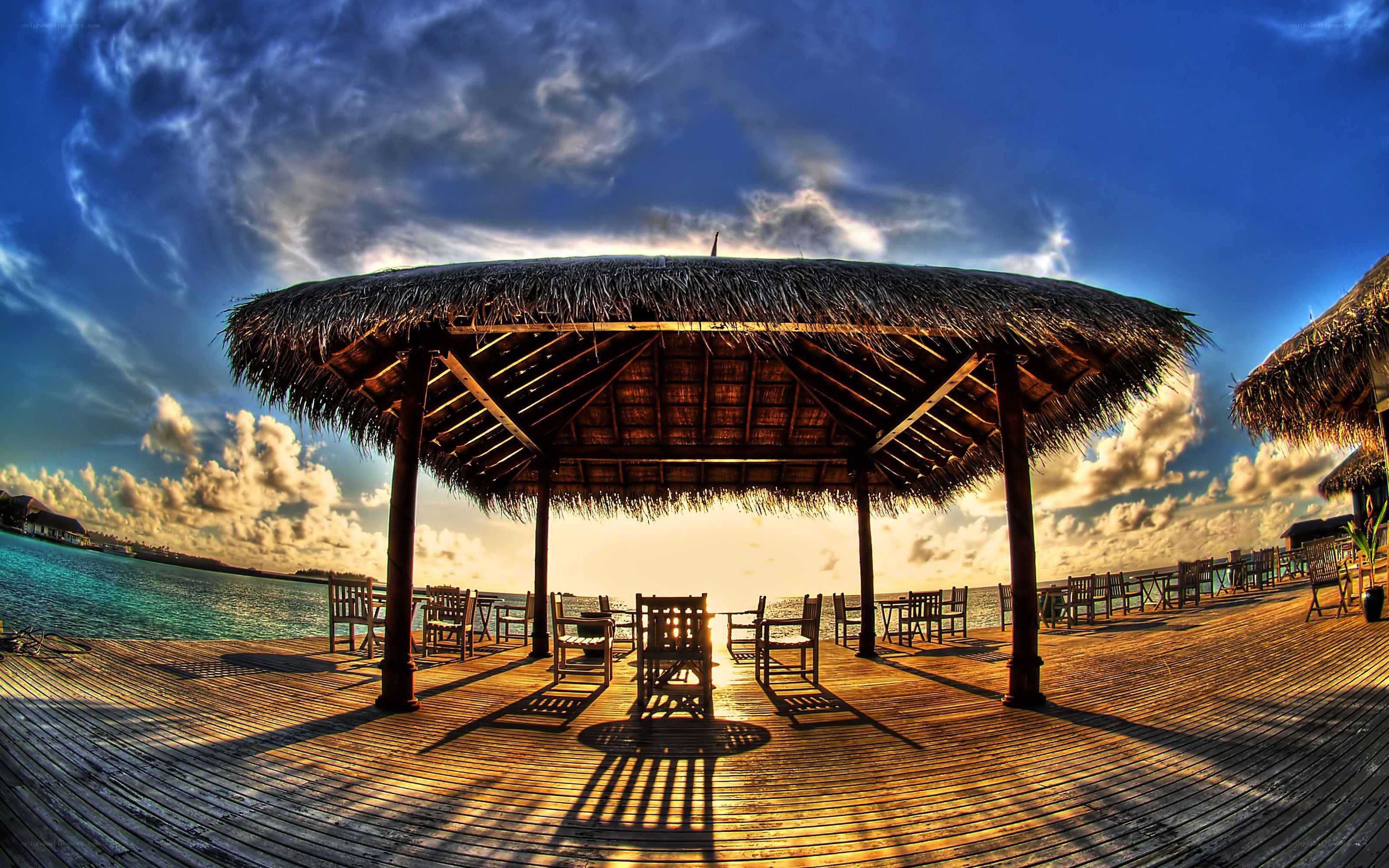 Thatched pavilion at sunset