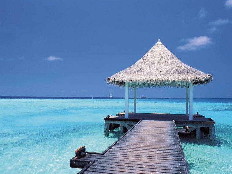 Thatched Pavilion on Pier — Blue, Serene, Afternoon, Photograph, Ocean, Sky