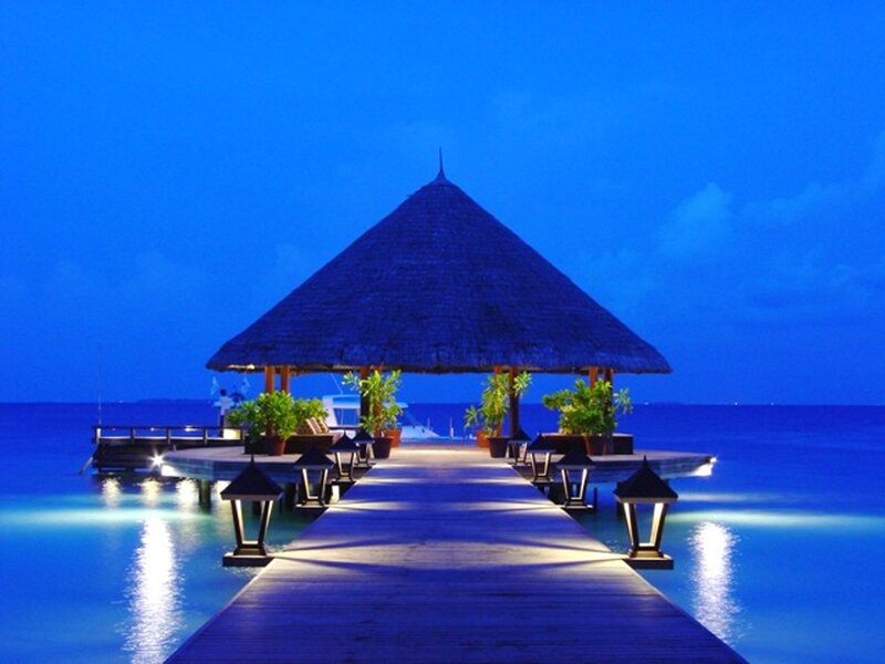 Thatched Pavilion on Pier — Blue, Serene, Night, Photograph