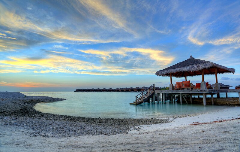 Thatched Pavilion on Pier — Blue, Serene, Sunset, Photograph, Beach