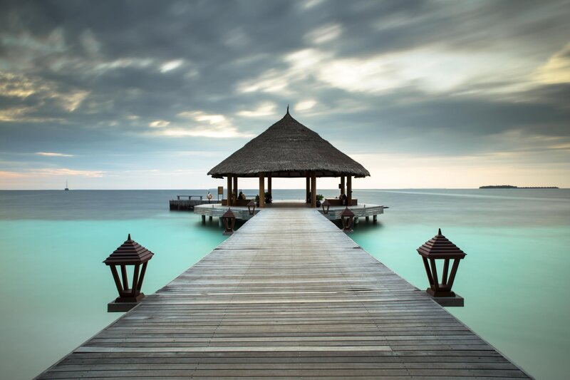 Thatched Pavilion on Pier — Blue, Serene, Sunset, Photograph, Lanterns