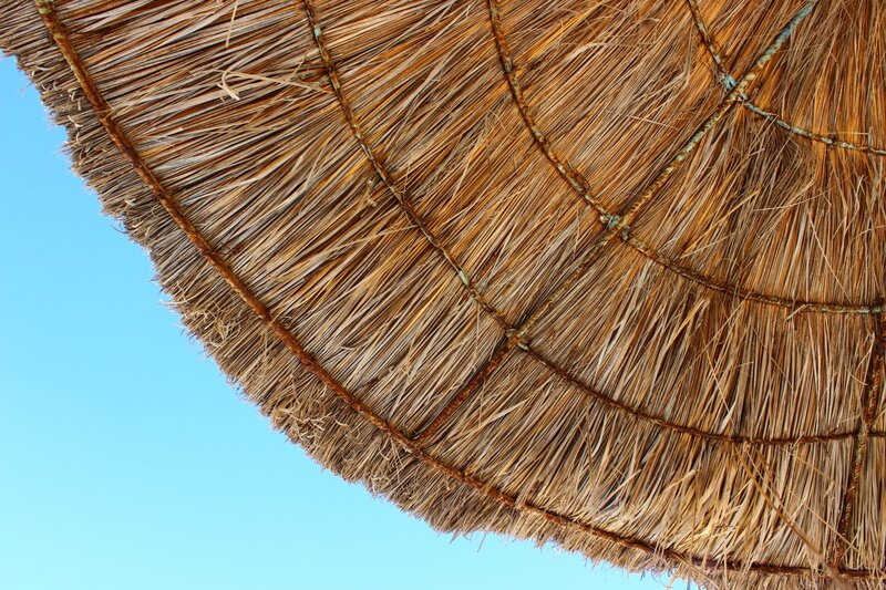 thatched roof against blue sky