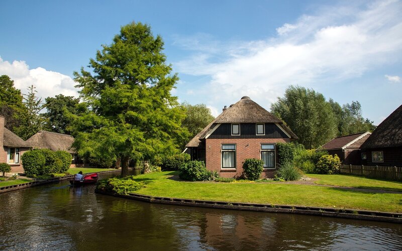 Thatched-roof House by Canal