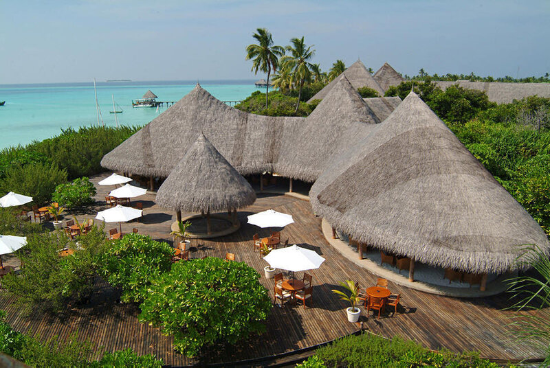 Thatched-roof resort over water