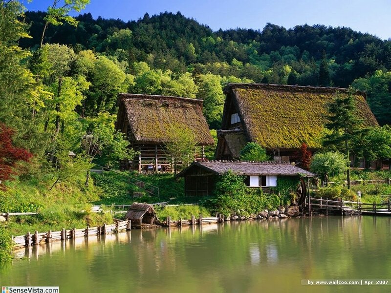 Thatched-roof village by a lake