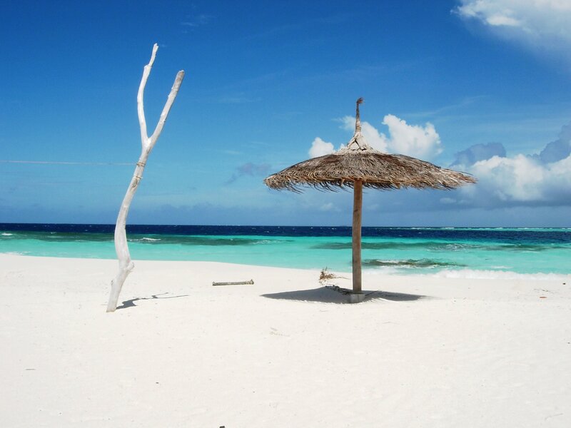 Thatched Umbrella on Beach — White