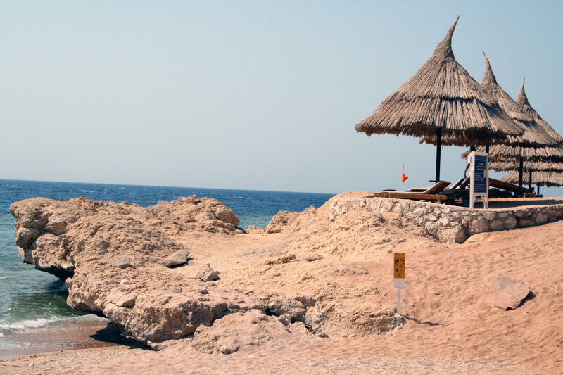 Thatched Umbrellas on Beach — Beige