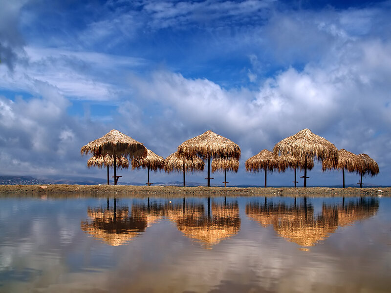 Thatched Umbrellas on Beach — Blue, Serene, Afternoon