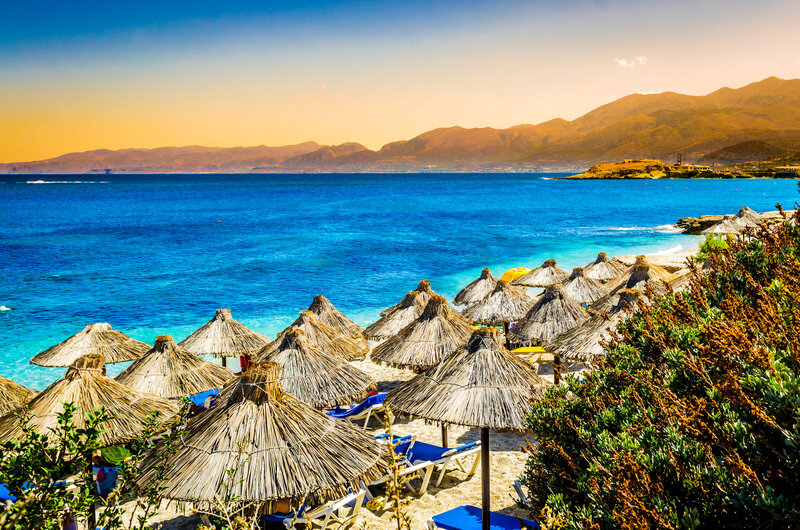 Thatched Umbrellas on Beach — Blue, Serene, Sunset, Photograph, Ocean