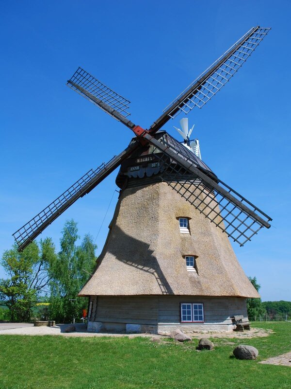 Thatched windmill under blue sky