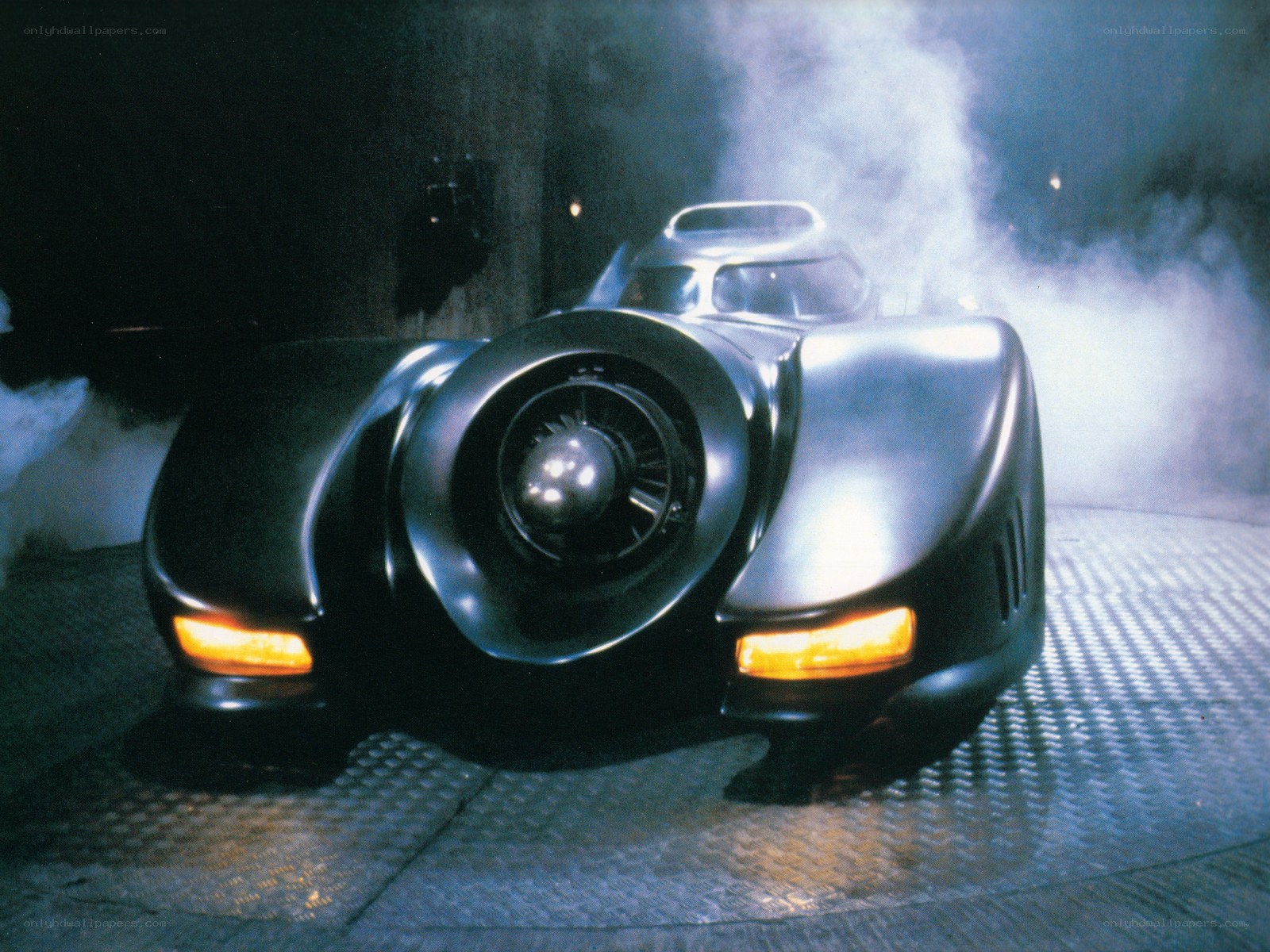 The Batmobile in a smoky garage