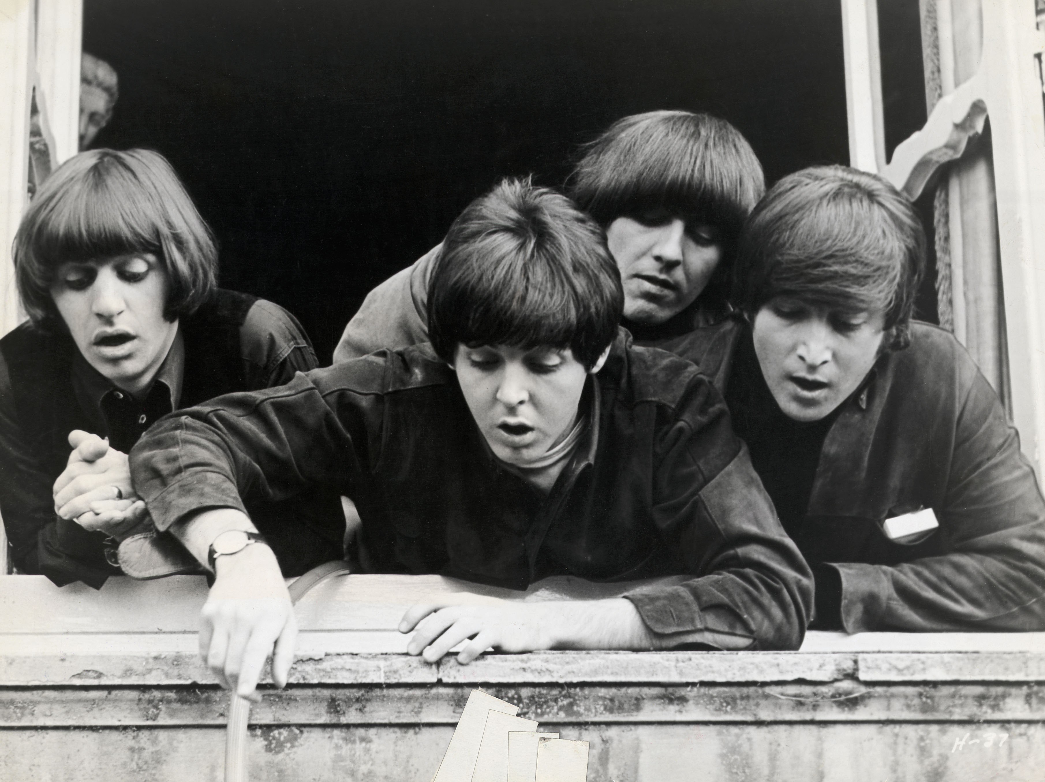 The Beatles at a window