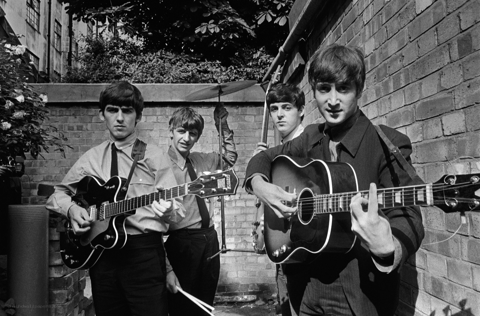 The Beatles in a courtyard