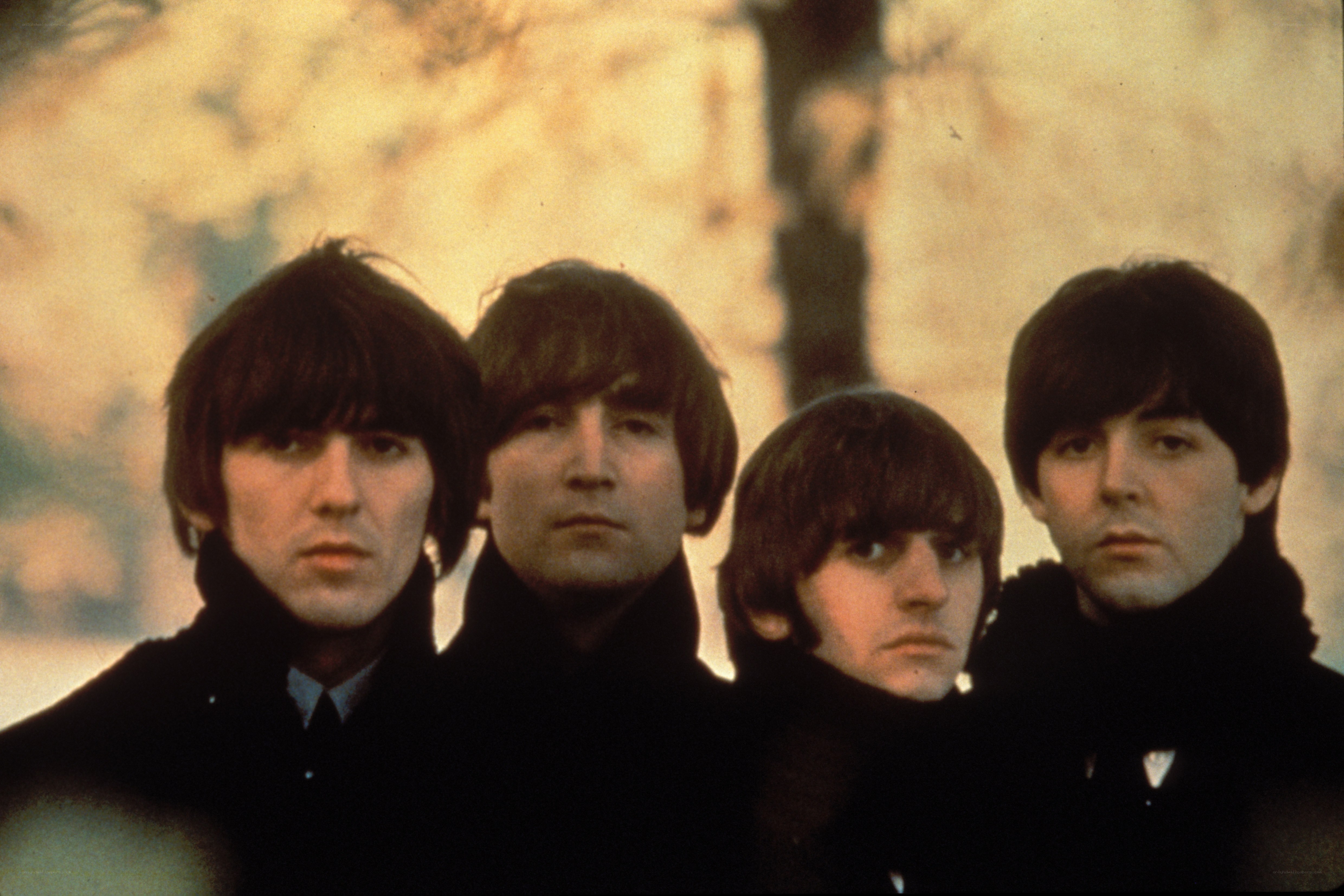 The Beatles in black coats
