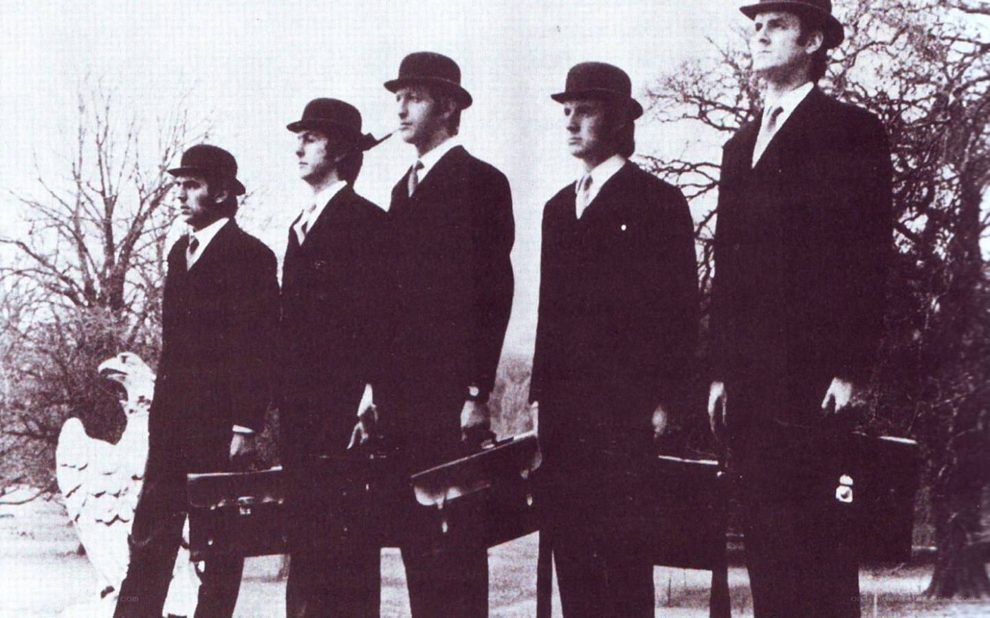 The Beatles in suits and hats