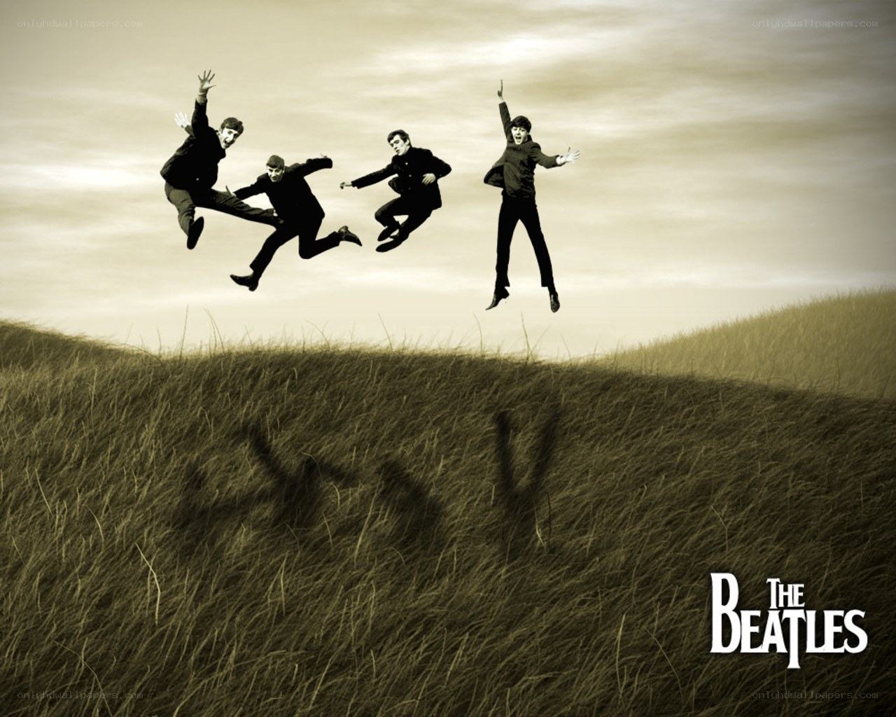 The Beatles jumping in a field