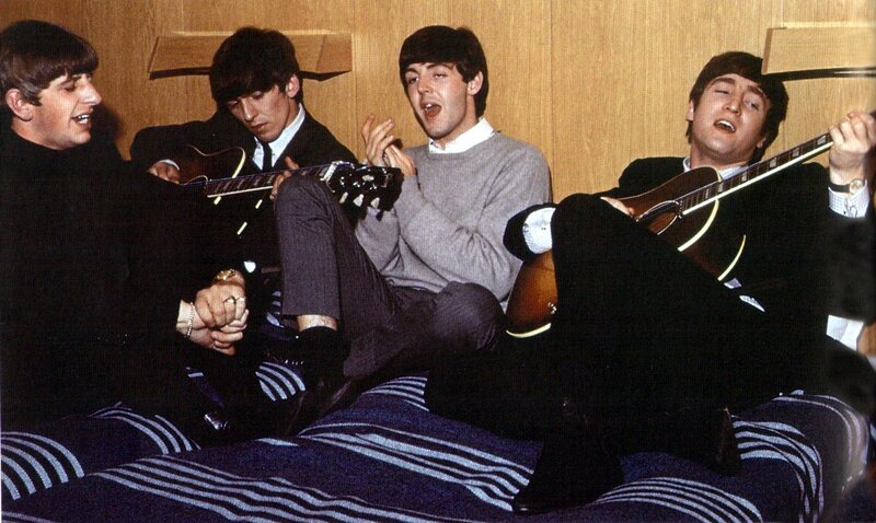 The Beatles on a bed